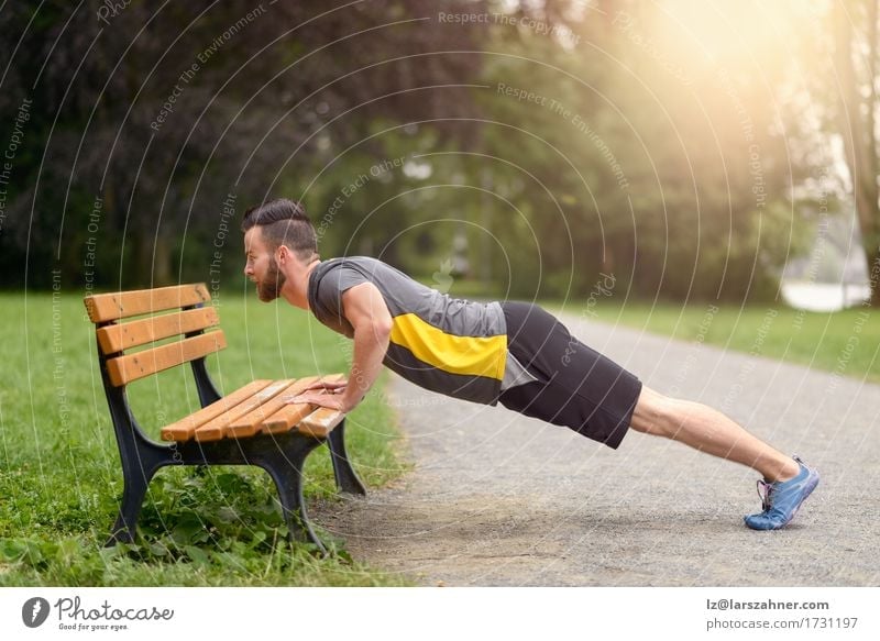 Young man doing push-ups in a park Lifestyle Body Face Sports Masculine Man Adults 1 Human being 18 - 30 years Youth (Young adults) Park Beard Fitness Action
