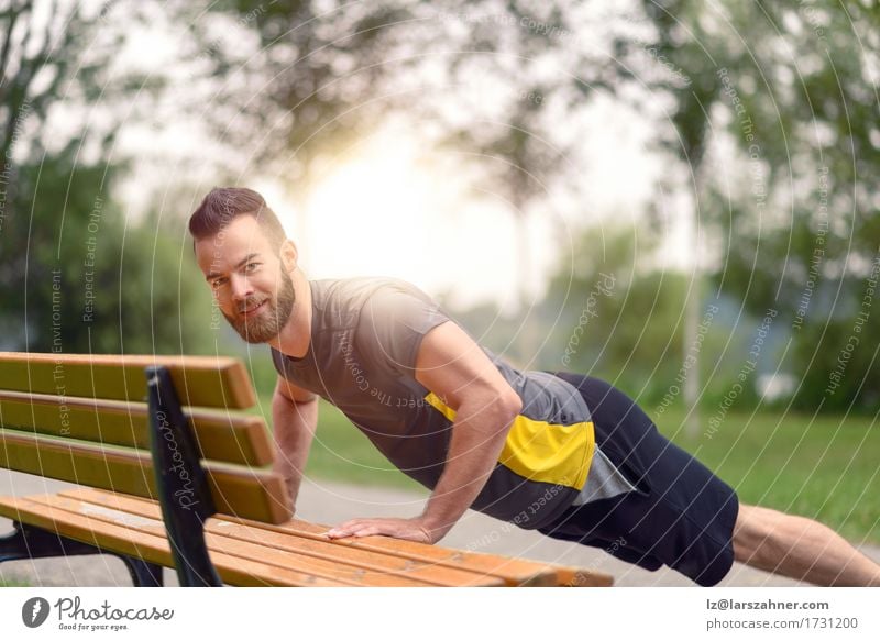 Young man doing push-ups in a park Lifestyle Body Face Sports Masculine Man Adults 1 Human being 18 - 30 years Youth (Young adults) Park Beard Fitness Action