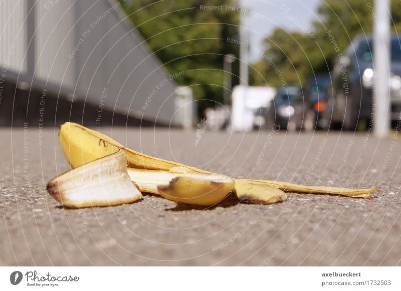 discarded banana skin on pavement Town Pedestrian Street Caution Insurance Banana banana peel Sidewalk Footpath Ground Discarded Copy Space Accident Risk