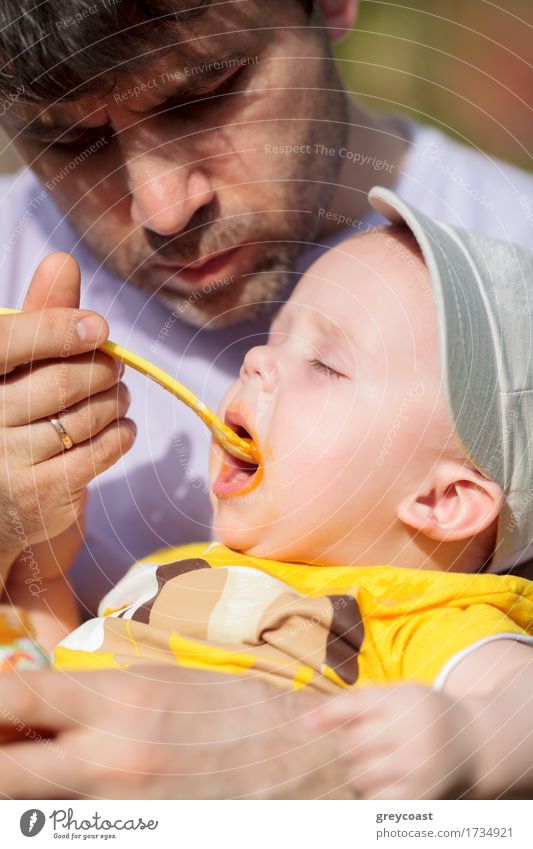 Daddy feeding toddler a spoonful of baby food Nutrition Dinner Milk Spoon Child Baby Toddler Boy (child) Young man Youth (Young adults) Father Adults