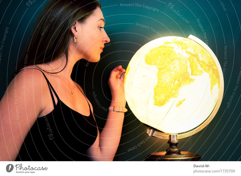 young woman looking at a shining globe Planet Earth Globe Young woman look at Observe explore travel magical Illuminate
