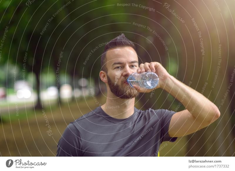 Young man drinking bottled water Drinking Lifestyle Face Summer Masculine Man Adults 1 Human being 18 - 30 years Youth (Young adults) Warmth Beard Fitness