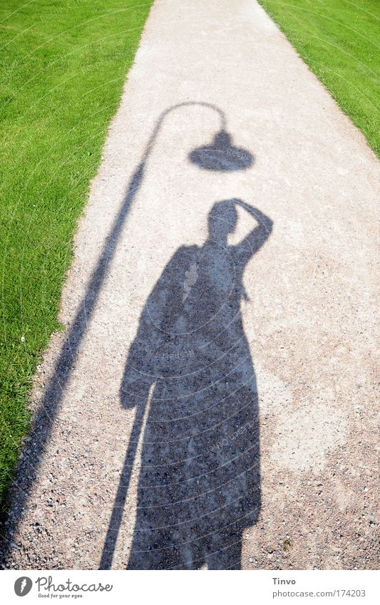 Hats off! Colour photo Exterior shot Day Light Shadow Contrast Silhouette 1 Human being Green Absurdity Joy Funny Lantern Lawn Sandy path Sidewalk Park