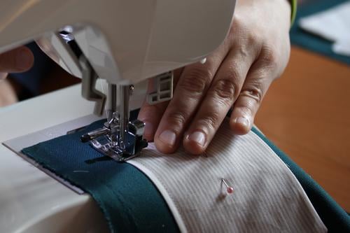 creative sewing lesson Sewing machine Human being Feminine Woman Adults Hand Fingers 1 30 - 45 years Authentic Uniqueness Brown Gray Green White Joy Creativity