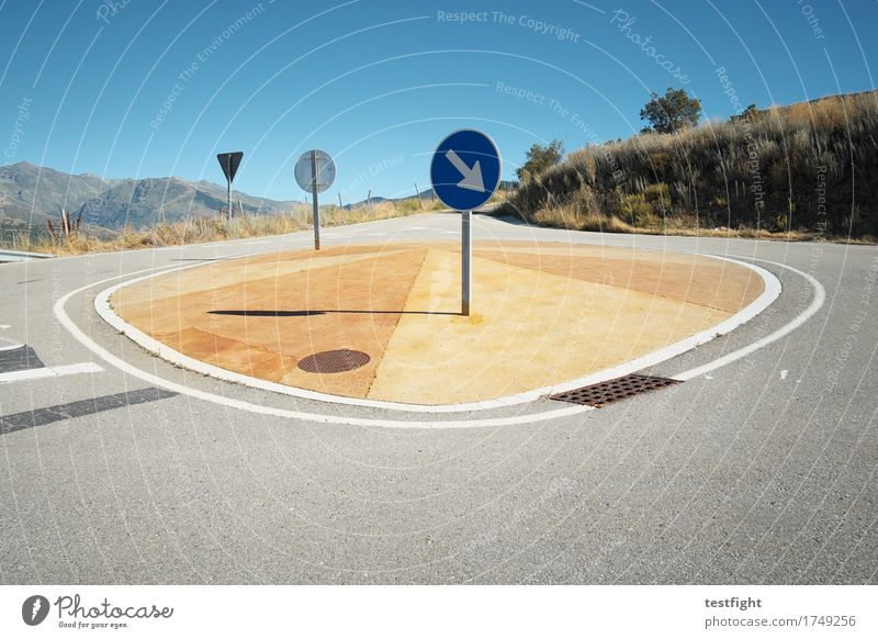 island Environment Nature Landscape Mountain Transport Traffic infrastructure Street Driving Blue Road sign Street refuge Traffic circle Pavement Colour photo