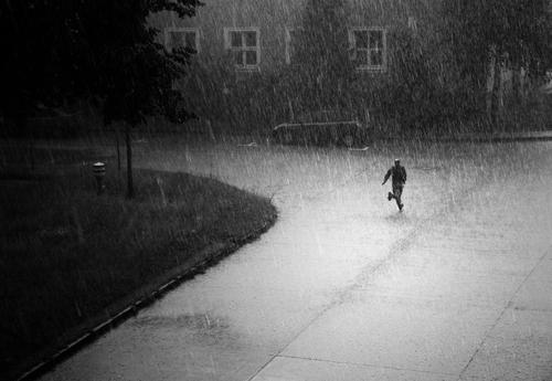 the curse Human being Masculine Walking Running Rain Thunder and lightning Gale Hail Loneliness Wet Damp Cold Escape Dry Black & white photo Exterior shot