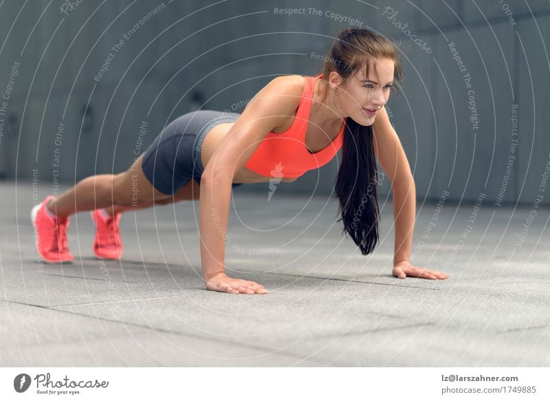Fit young woman doing push-ups Lifestyle Summer Sports Woman Adults 1 Human being 18 - 30 years Youth (Young adults) Small Town Brunette Fitness Thin athletic