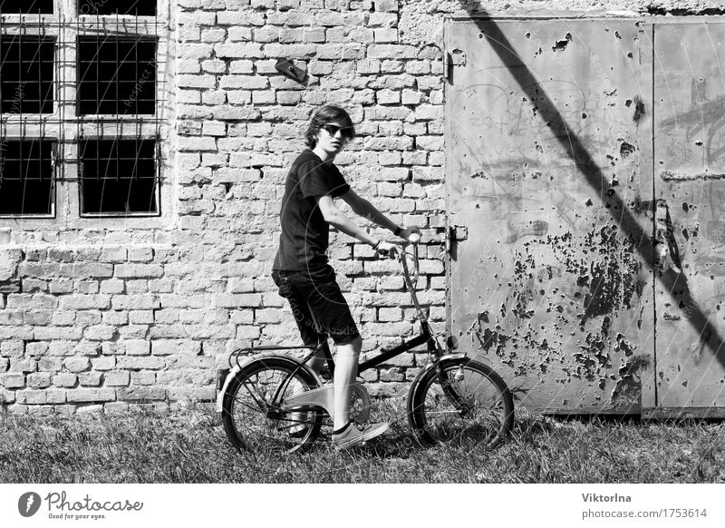 young boy - old bicycle Cycling tour Industry Young man Youth (Young adults) 1 Human being 13 - 18 years Facade Stone Rust Brick Old Hideous Town Gray Style