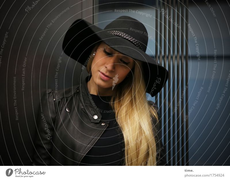 . Feminine Woman Adults 1 Human being Means of transport Elevator Jacket Hat Blonde Long-haired Observe Think Stand Wait Beautiful Self-confident Safety