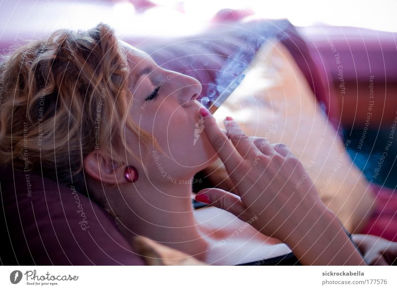 smoke Colour photo Interior shot Day Shallow depth of field Central perspective Upper body Profile Closed eyes Smoking Sofa Human being Feminine Young woman