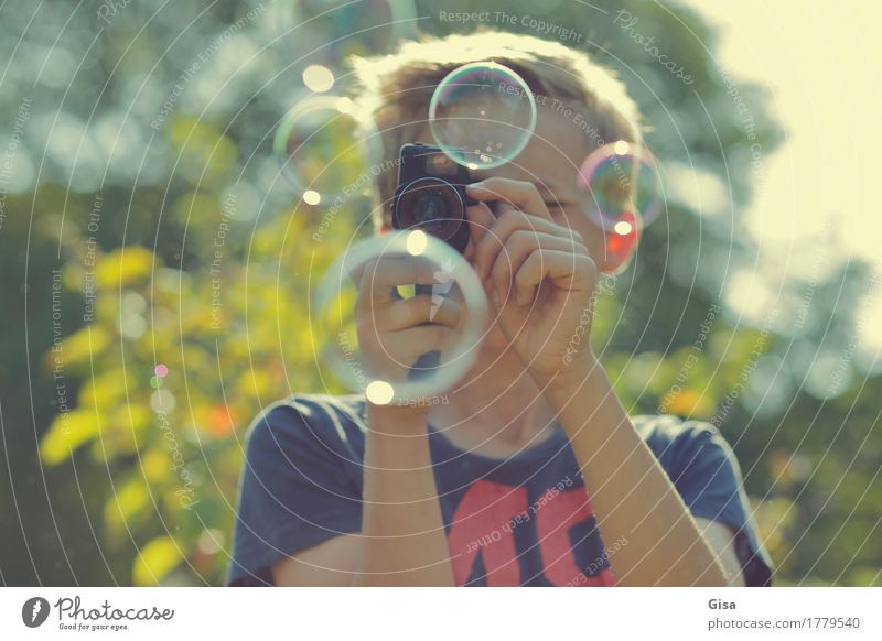 Bub films soap bubbles outdoors in sunlight with a Super 8 camera. Leisure and hobbies Filming Summer Garden Video camera Human being Masculine Boy (child) 1