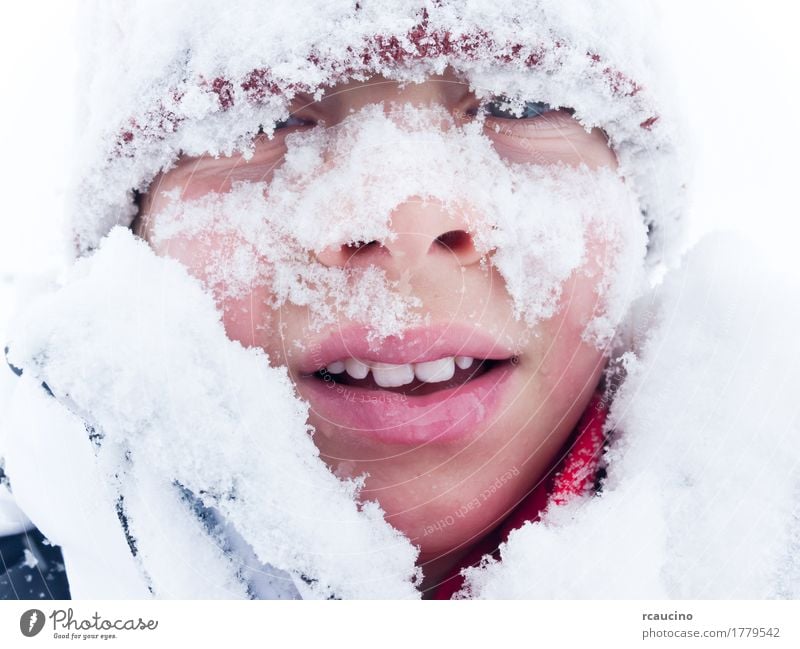 Portrait of a child covered with snow Lifestyle Joy Winter Snow Mountain Child Boy (child) Man Adults Smiling White Loneliness Beret cap Caucasian cold