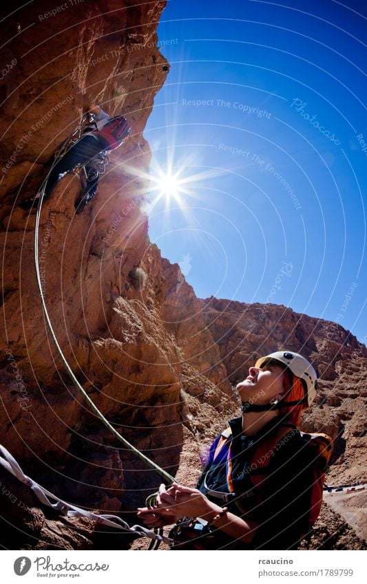 A female climber belays during a climbing in Morocco Face Vacation & Travel Adventure Expedition Summer Sun Mountain Sports Climbing Mountaineering Rope Girl