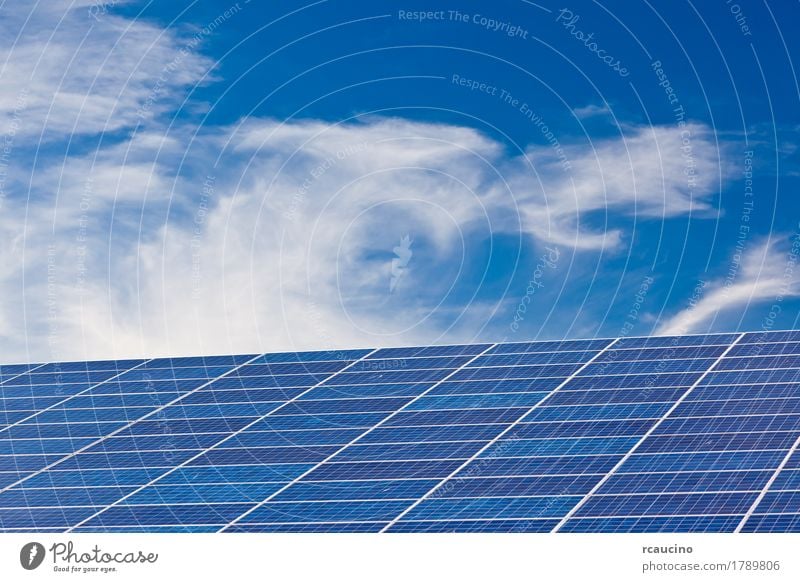 Photovoltaic panels in a solar power plant over a blue sky. Industry Solar Power Environment Sky Clouds Climate Natural Clean Blue Green Energy Alternative