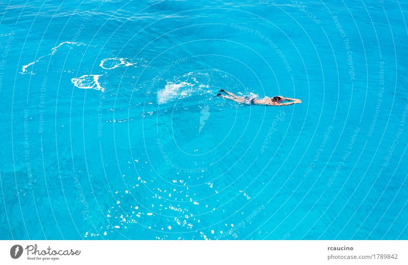 A caucasian young man swimming in blue sea water Joy Relaxation Vacation & Travel Summer Ocean Man Adults Blue White Loneliness clear Horizontal lampedusa