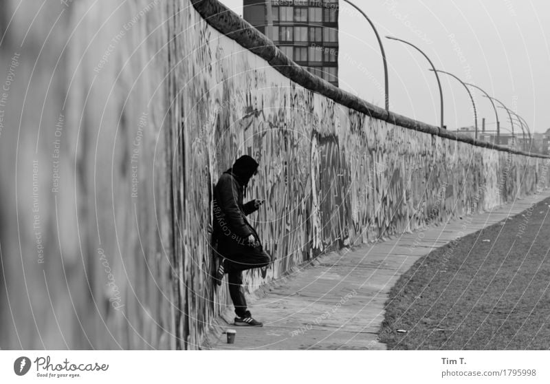 autumn Berlin Wall (barrier) Wall (building) Stagnating Border The Wall Cellphone Telephone Black & white photo Graffiti Exterior shot Day