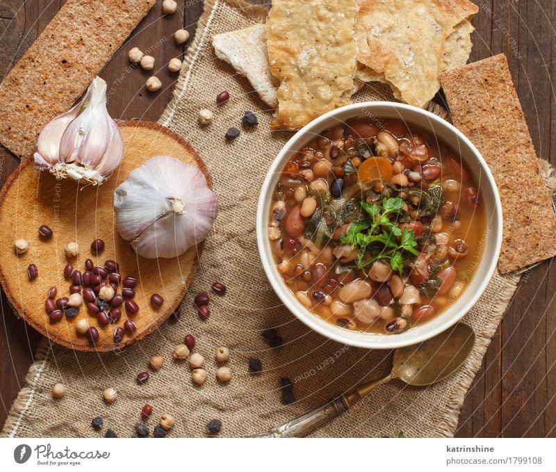 Cooked legumes and vegetables in a bowl Vegetable Bread Soup Stew Herbs and spices Nutrition Vegetarian diet Bowl Spoon Wood Delicious Natural Brown Green Red