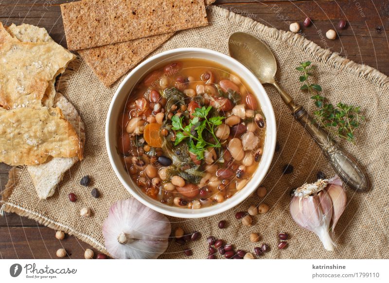 Cooked legumes and vegetables in a bowl Vegetable Bread Soup Stew Herbs and spices Nutrition Vegetarian diet Bowl Spoon Wood Delicious Natural Brown Green Red