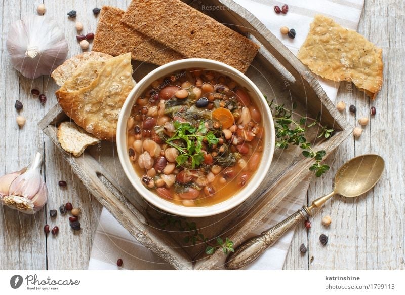 Cooked legumes and vegetables in a bowl Food Vegetable Bread Soup Stew Herbs and spices Nutrition Vegetarian diet Bowl Spoon Wood Delicious Natural Brown Green