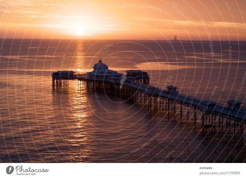 Sun rising over Llandudno pier Colour photo Exterior shot Structures and shapes Deserted Morning Dawn Day Silhouette Reflection Sunlight Sunbeam Sunrise Sunset