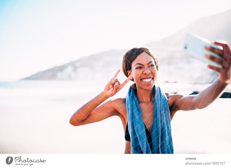 African young woman taking funny selfie with smartphone Joy Happy Beach Ocean Sports Yoga Telephone Camera Technology Human being Young woman