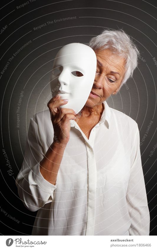 mature woman revaling sad face behind mask Human being Woman Adults Female senior Senior citizen 1 60 years and older Actor Sadness White Emotions Identity