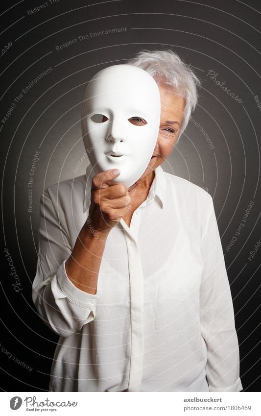 happy mature woman peeking from behind mask Joy Playing Human being Woman Adults Female senior Grandmother Senior citizen 1 60 years and older Actor Smiling