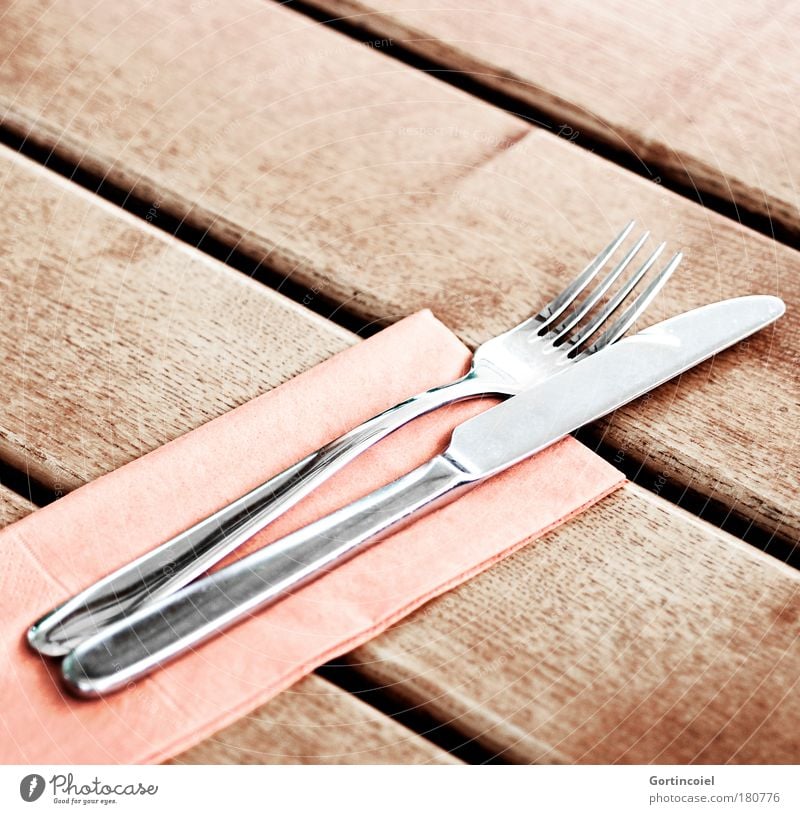 precious metal Napkin Set meal Cutlery Knives Fork Point Table Restaurant Metal Glittering Silver Wood Wooden table Colour photo Subdued colour Exterior shot