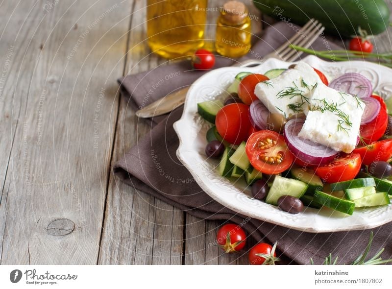 Greek salad Cheese Vegetable Lunch Dinner Vegetarian diet Plate Bottle Table Fresh Green Red Tomato chery tomatoes Feta cheese Cucumber onions Olive oil