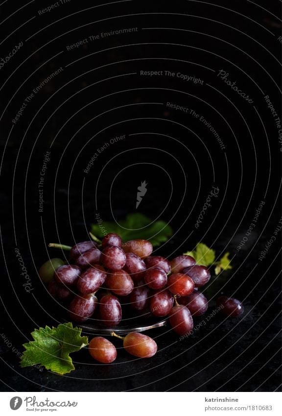 Red grapes on a silver bowl Fruit Nutrition Bowl Table Wood Dark Fresh Retro Green Agriculture Berries Food Bunch of grapes Grape vine Grapevine Harvest Health