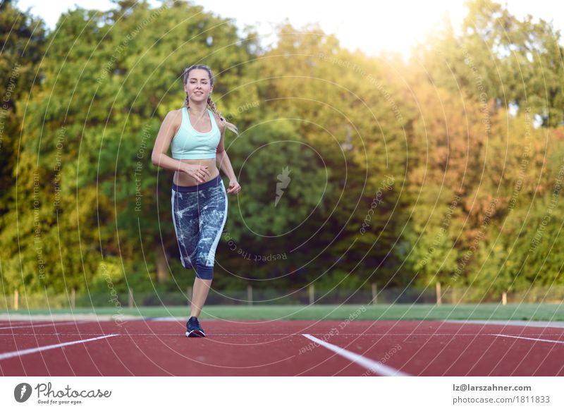Female athlete training for a race Happy Face Sports Racecourse Woman Adults 1 Human being 18 - 30 years Youth (Young adults) Blonde Fitness Smiling Power