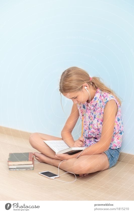 Schoolgirl reading a book in classroom Lifestyle Reading Classroom Schoolchild Academic studies Workplace Tool Girl 1 Human being 13 - 18 years