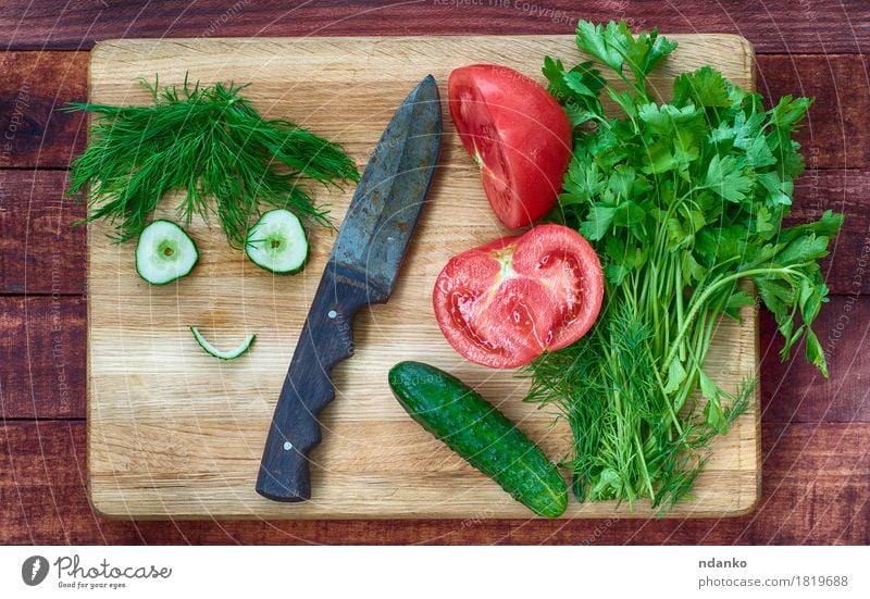 Tomato and cucumber salad on a kitchen board Food Vegetable Herbs and spices Eating Knives Face Kitchen Man Adults Eyes Smiling Funny Cute Brown Green Red