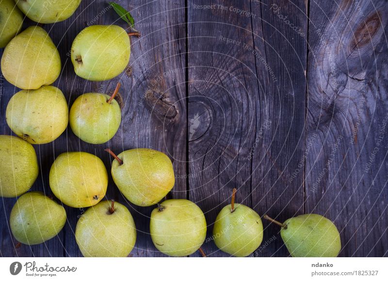Small yellow ripe pears on a wooden gray surface Fruit Vegetarian diet Diet Summer Table Tree Wood Old Fresh Delicious Natural Yellow Gray Green agriculture
