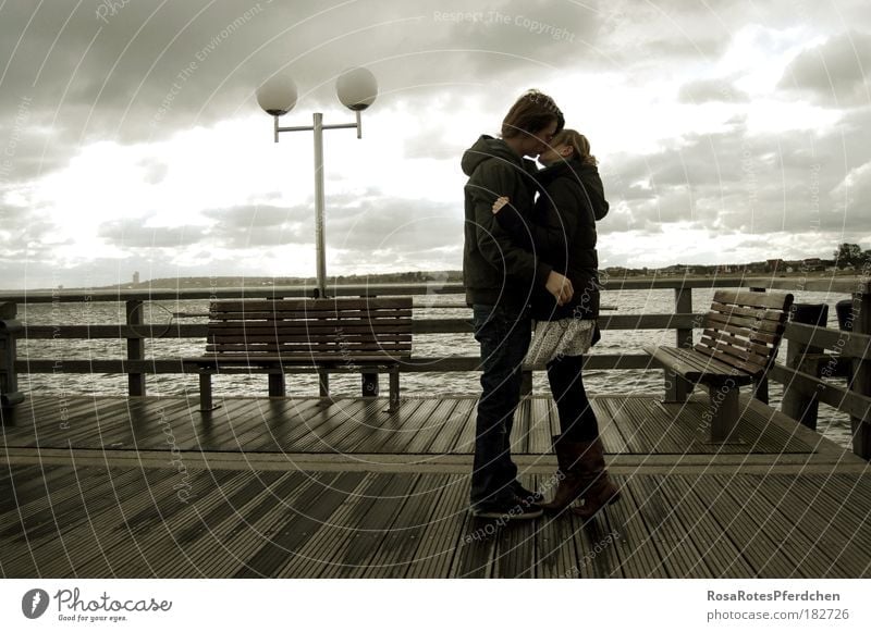 A kiss in wind and weather Kissing Couple Dark Clouds Sky Weather Lamp Ocean Bridge Love Youth (Young adults) Romance Exterior shot Lovers Relationship Trust