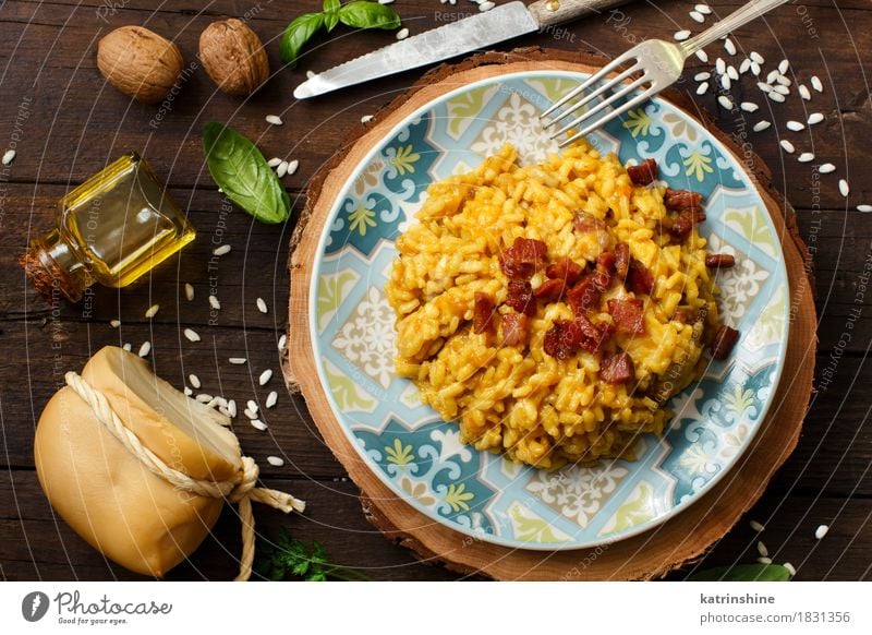 Risotto with a pumpkin and bacon Cheese Vegetable Grain Herbs and spices Cooking oil Nutrition Lunch Dinner Diet Plate Bowl Bottle Fork Wood Bright Delicious