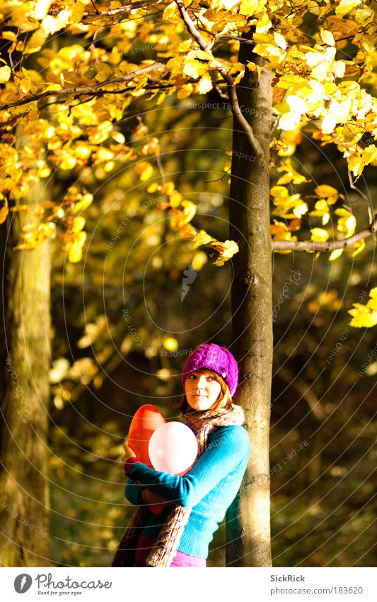 . Human being Feminine Young woman Youth (Young adults) 1 18 - 30 years Adults Autumn Tree Forest Sweater Scarf Cap Balloon Smiling Yellow Violet Moody Serene