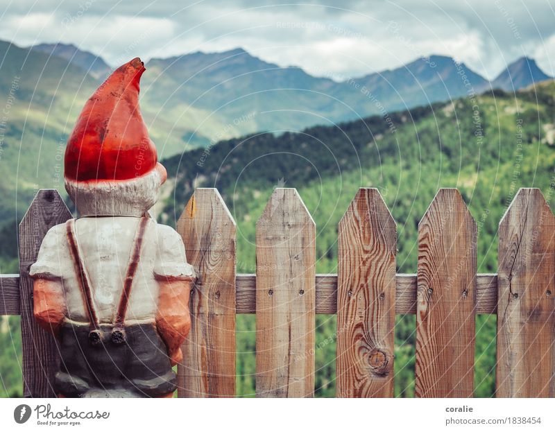 mountain dwarf Alps Mountain Peak Observe Dwarf Fence Fence post Red Little Red Riding Hood Cap Suspenders View from a window Vantage point Back Rear view Small