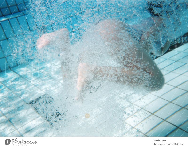 Underwater shot. Young woman makes swimming movements with her lower body in the water basin. Water bubbles Colour photo Underwater photo Copy Space bottom Life