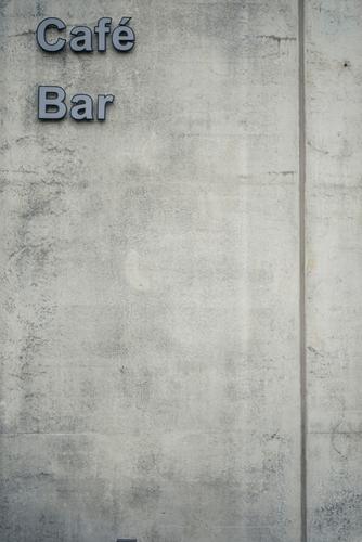 Concrete Café / Bar Wall (barrier) Wall (building) Characters Gray Town Lettering Signs and labeling Colour photo Exterior shot Deserted Day