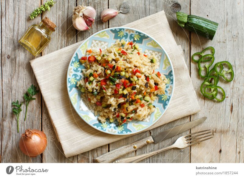 Risotto with vegetables on a wooden table Vegetable Grain Herbs and spices Cooking oil Nutrition Lunch Dinner Vegetarian diet Diet Italian Food Plate Bottle