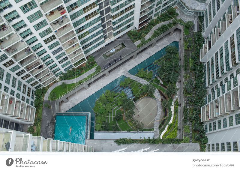 Aerial view of decorative green garden with people, water scene and swimming pool in residential area Luxury Design Relaxation Swimming pool Flat (apartment)