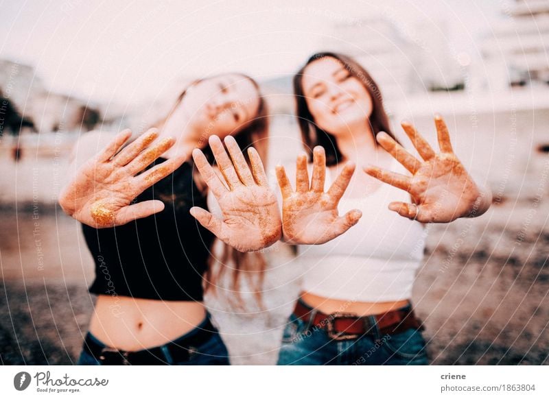 Teenage girls stretching out hands with golden glitter Lifestyle Style Make-up Decoration Feasts & Celebrations Girl Young woman Youth (Young adults) Woman