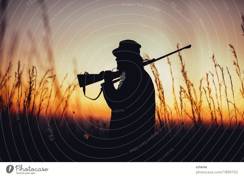 Hunter holding shotgun on shoulder and observing land Meat Lifestyle Hunting Summer Sports Man Adults Male senior Nature Warmth Grass Meadow Field Hat Carrying