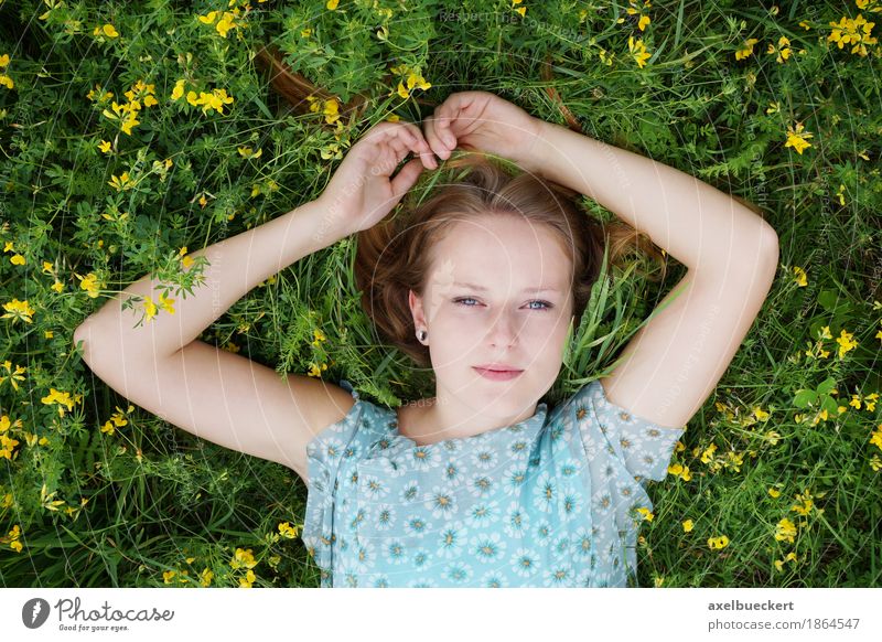 young woman lies on a flower meadow Lifestyle Well-being Contentment Relaxation Leisure and hobbies Summer Human being Feminine Young woman Youth (Young adults)