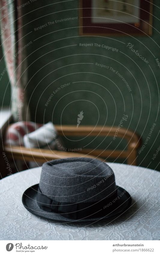 Felt hat on table in front of vintage wall Lifestyle Shopping Luxury Elegant Style Interior design Furniture Wallpaper Room Drape Image Picture frame Lounge