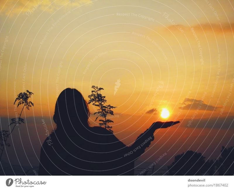 Beautiful Silhoutte and Sunset and Woman holding Sun in hand Wellness Life Harmonious Well-being Senses Relaxation Calm Meditation Environment Nature Landscape