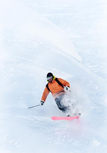 Young male freeride skier making a turn in powder snow Winter Snow Mountain Sports Skiing Man Adults White Caucasian Ski-run Extreme freerider ice one orange