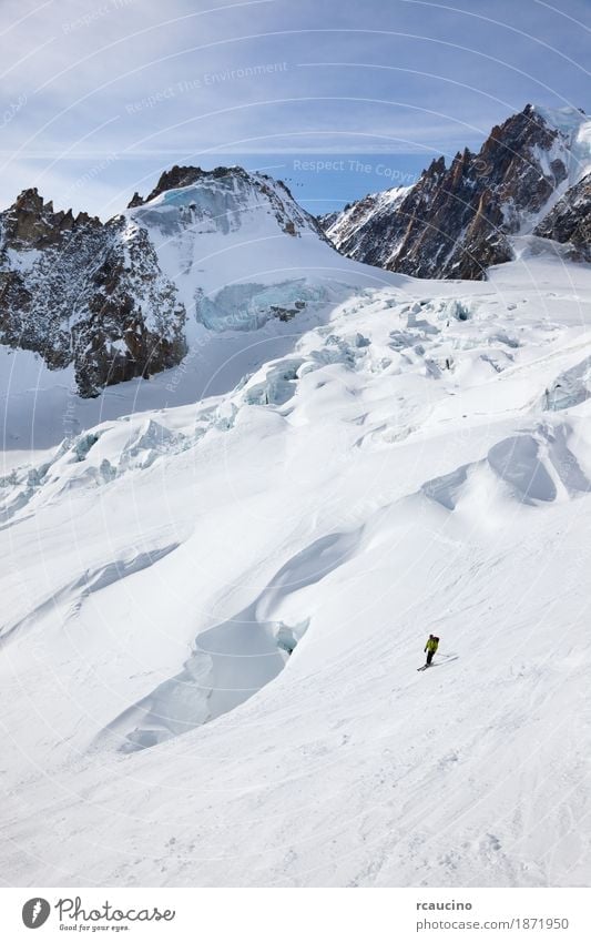 Male skier moving down in snow powder Joy Adventure Winter Snow Mountain Sports Skiing Man Adults Landscape Sky Glacier Green Clear sky Extreme freeride