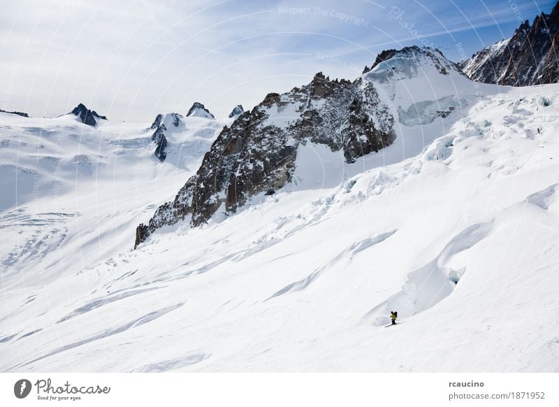 Male skier moving down in snow powder Joy Adventure Winter Snow Mountain Sports Skiing Man Adults Landscape Sky Glacier Green Clear sky Extreme freeride
